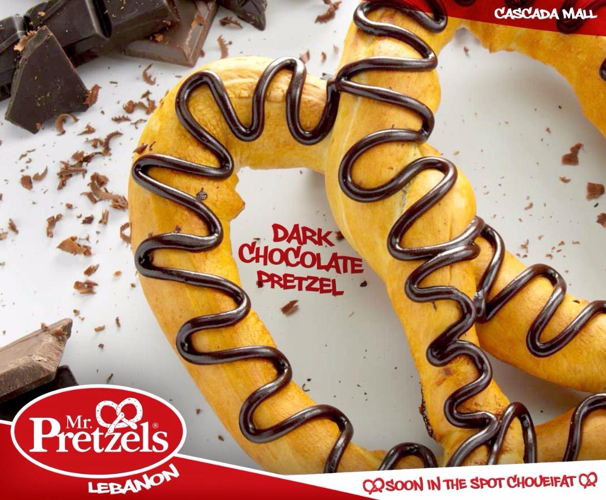 A pretzel with dark chocolate drizzle.